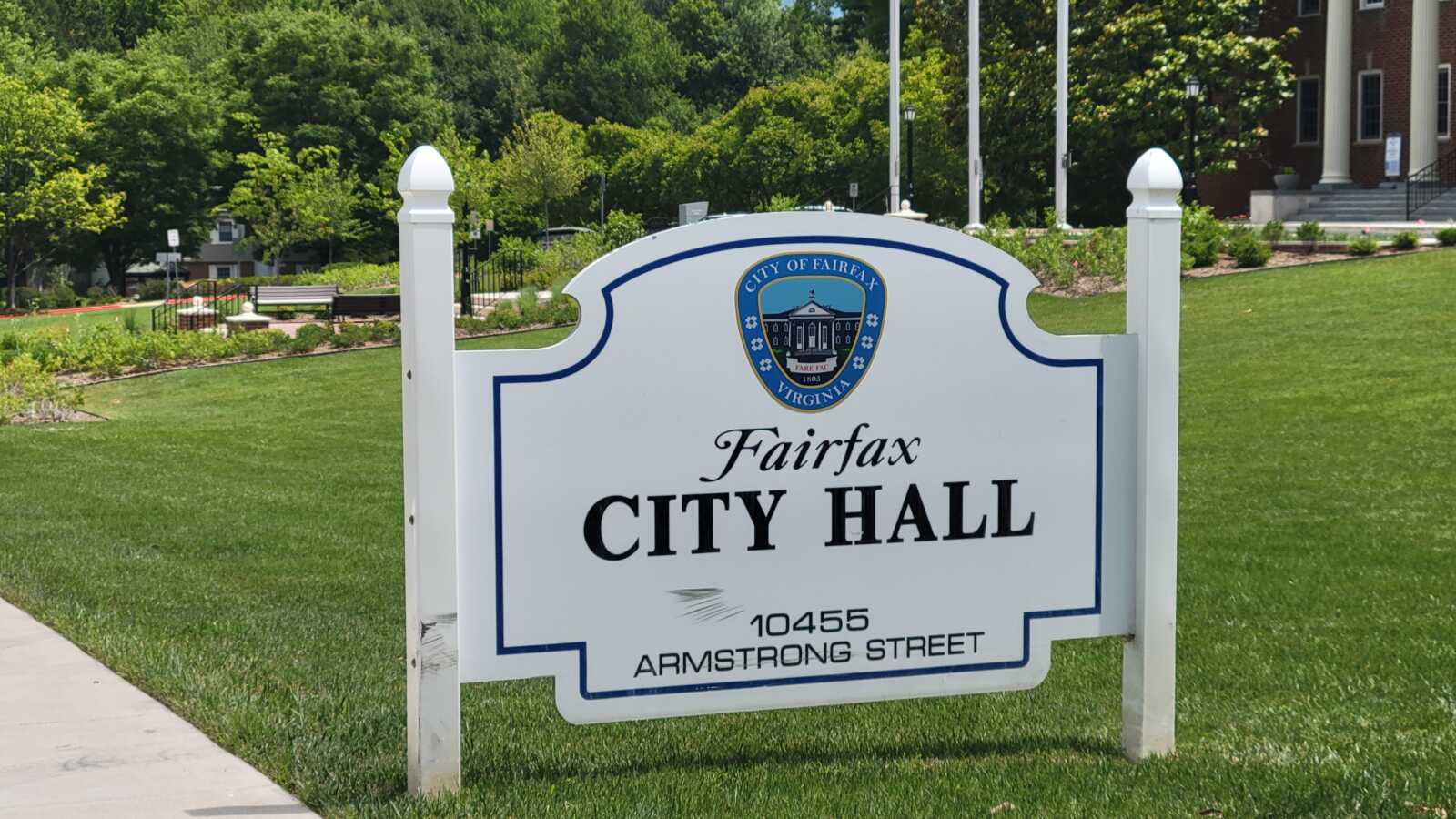 The sign in front of Fairfax City Hall (staff photo by Mary Stachyra Lopez) | FFXnow