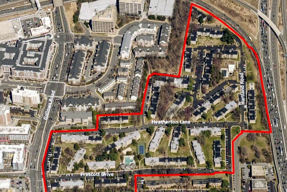 Boundaries, in red, of Merrifield at Dunn Loring Station Apartments (via Fairfax County) | FFXnow Aerial view of a residential neighborhood with a red boundary outlining a specific area near a major highway on the right; streets labeled Prescott Drive and Heatherton Lane are visible.