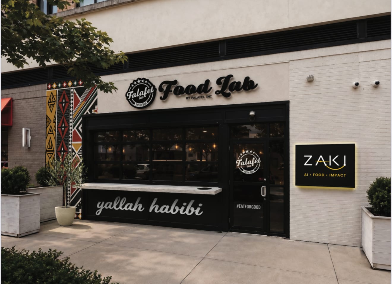 A rendering of Falafel Inc.'s new flagship restaurant at the Mosaic District in Merrifield (courtesy Falafel Inc.) | FFXnow Front of a falafel shop with a bold 'Food Lab' sign and 'yallah habibi' script on the counter window, and a black ZAKI sign on the right wall.