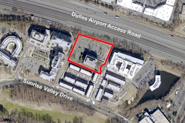 Aerial view of an office campus with a building outlined in red along Dulles Airport Access Road, near Sunrise Valley Drive.