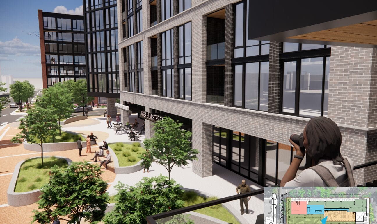 Modern mixed-use building with a brick facade overlooking a landscaped courtyard; people sit and walk along terraced planters while a photographer on the right uses a camera to scan the scene. Sign reads '6824 Elm Street'.