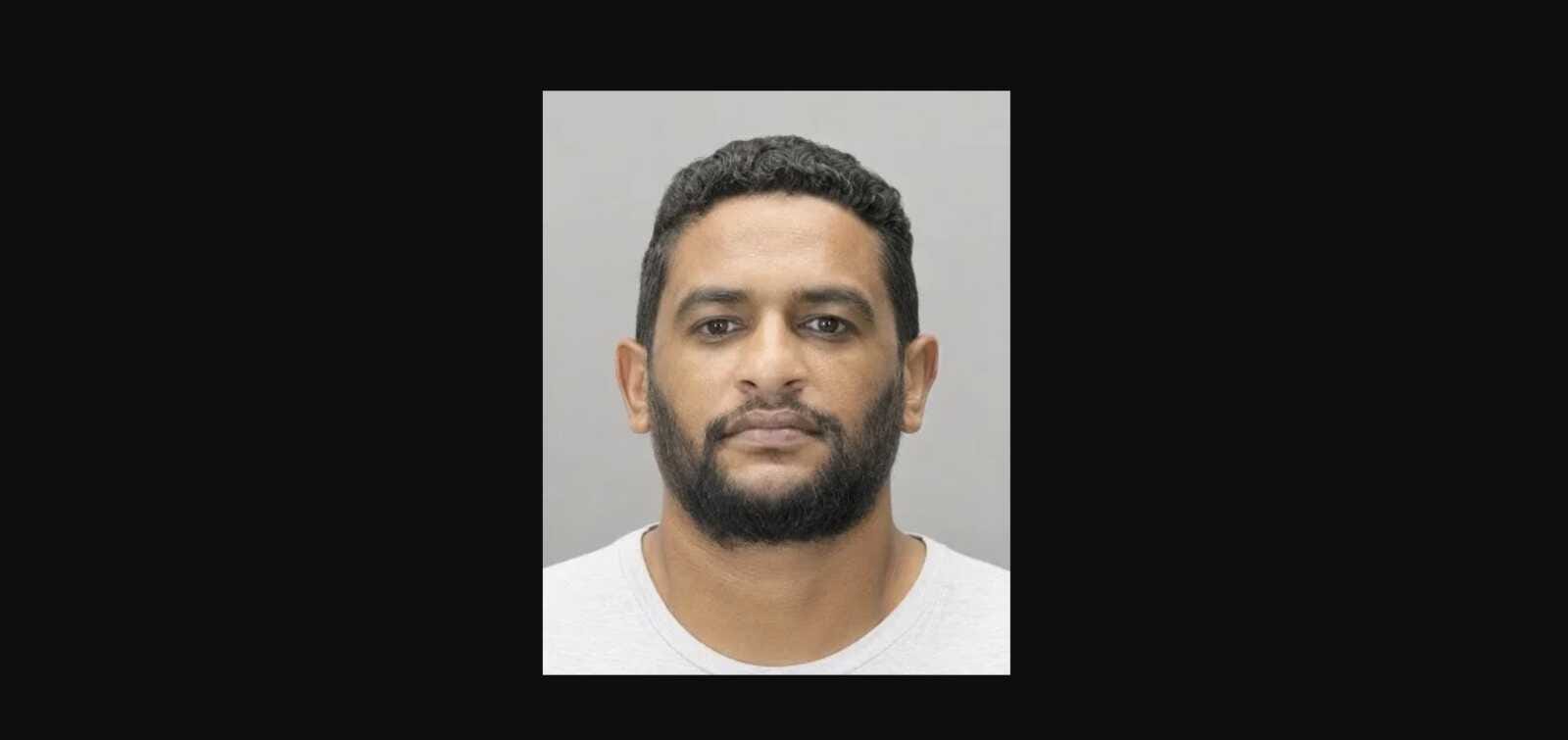 Ahmed Mohamed (courtesy Fairfax County Police Department) | FFXnow Mugshot of a man with short dark hair and a full beard against a gray background.
