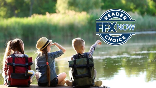 Three kids with backpacks sit by a sunny lake, pointing toward the water; large “Reader FFX Now Choice” logo overlays the scene.