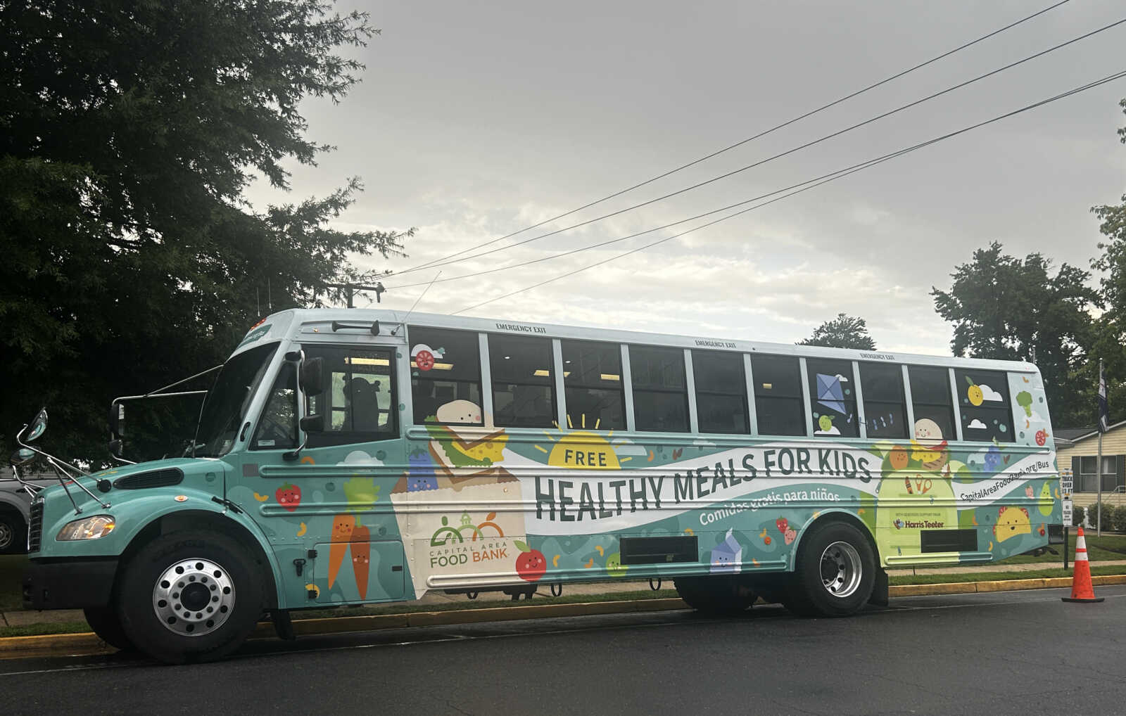 Colorful school bus with child-friendly illustrations and the words 'Healthy Meals for Kids' on the side, promoting free meals for kids.
