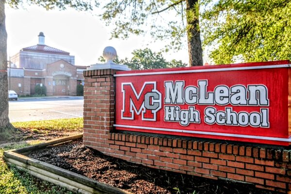Red brick sign reading 'McLean High School' with large MC logo in front of the campus entrance.
