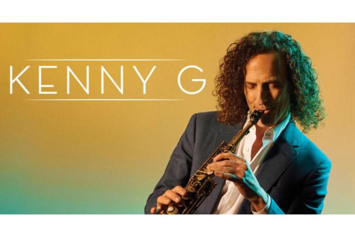 Promotional banner with the text 'KENNY G' on the left and a man in a suit playing a saxophone against a warm gradient background.