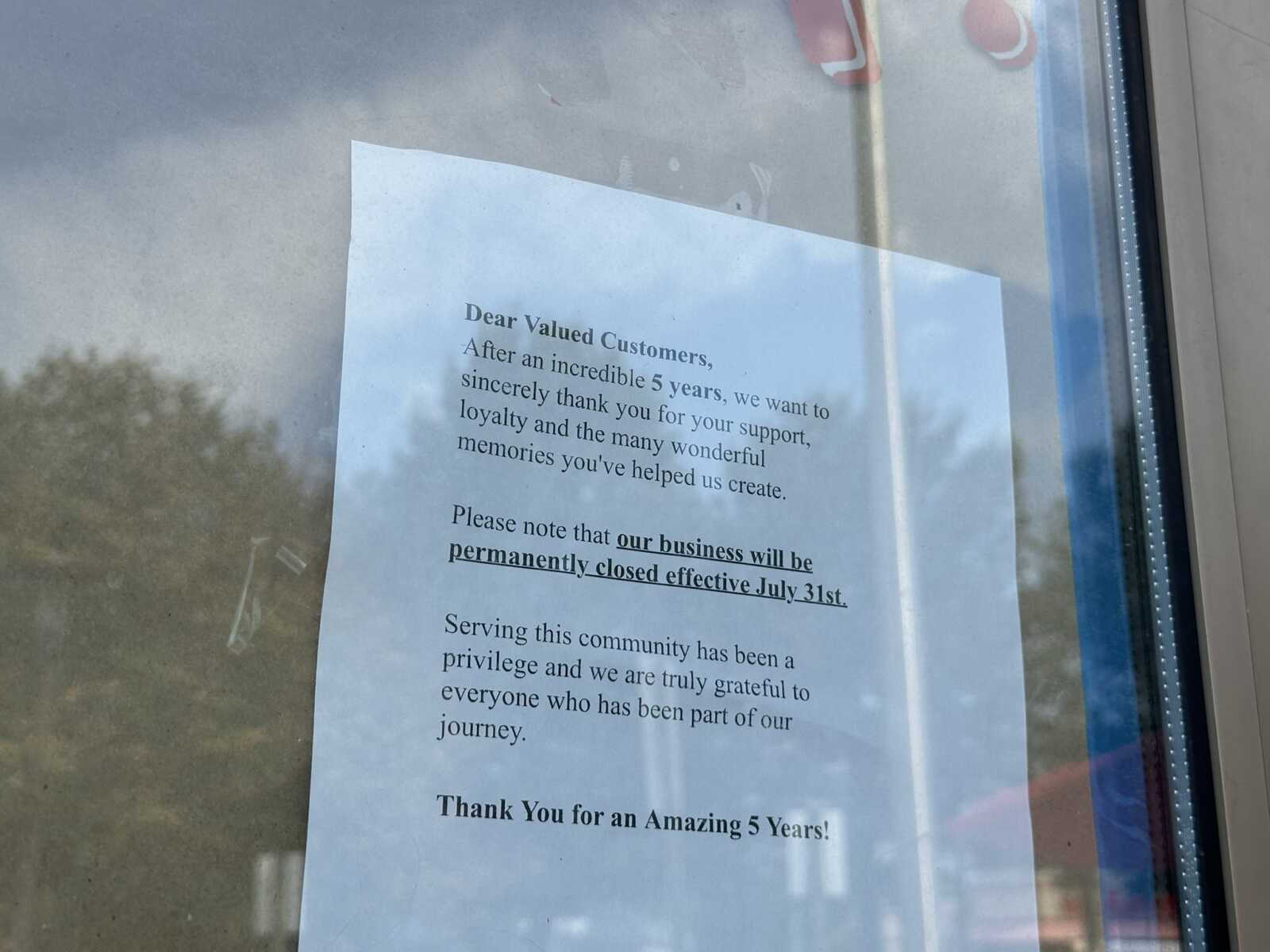 Letter posted on a window thanking customers; notes the business will permanently close July 31st.