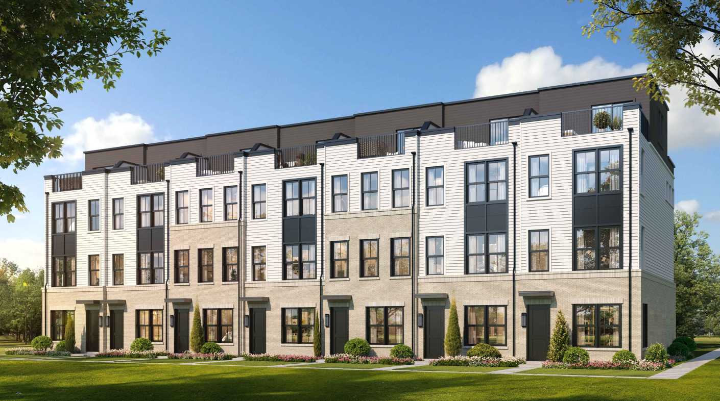 Row of modern townhomes with light brick, white siding, black-framed windows, and small front yards.