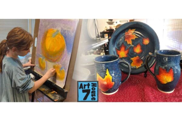 A girl paints on an easel in a pottery studio; autumn-orange pumpkins on canvas beside blue-glazed mugs and a plate with maple leaf designs on display.