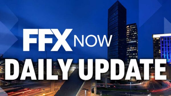 Banner image with bold white text 'FX NOW DAILY UPDATE' over a blue cityscape background (informational, for a daily update).