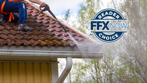 Worker in safety gear pressure-washes a mossy clay tile roof beside a white gutter, with a blue circular 'FFX NOW CHOICE' badge overlay on the right.