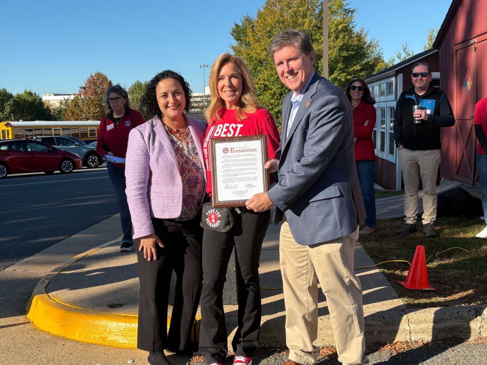 Providence District Supervisor Dalia Palchik and Hunter Mill District Supervisor Walter Alcorn present a resolution to Food for Neighbors founder Karen Joseph celebrating the nonprofit's 10th anniversary (courtesy Food for Neighbors) | FFXnow