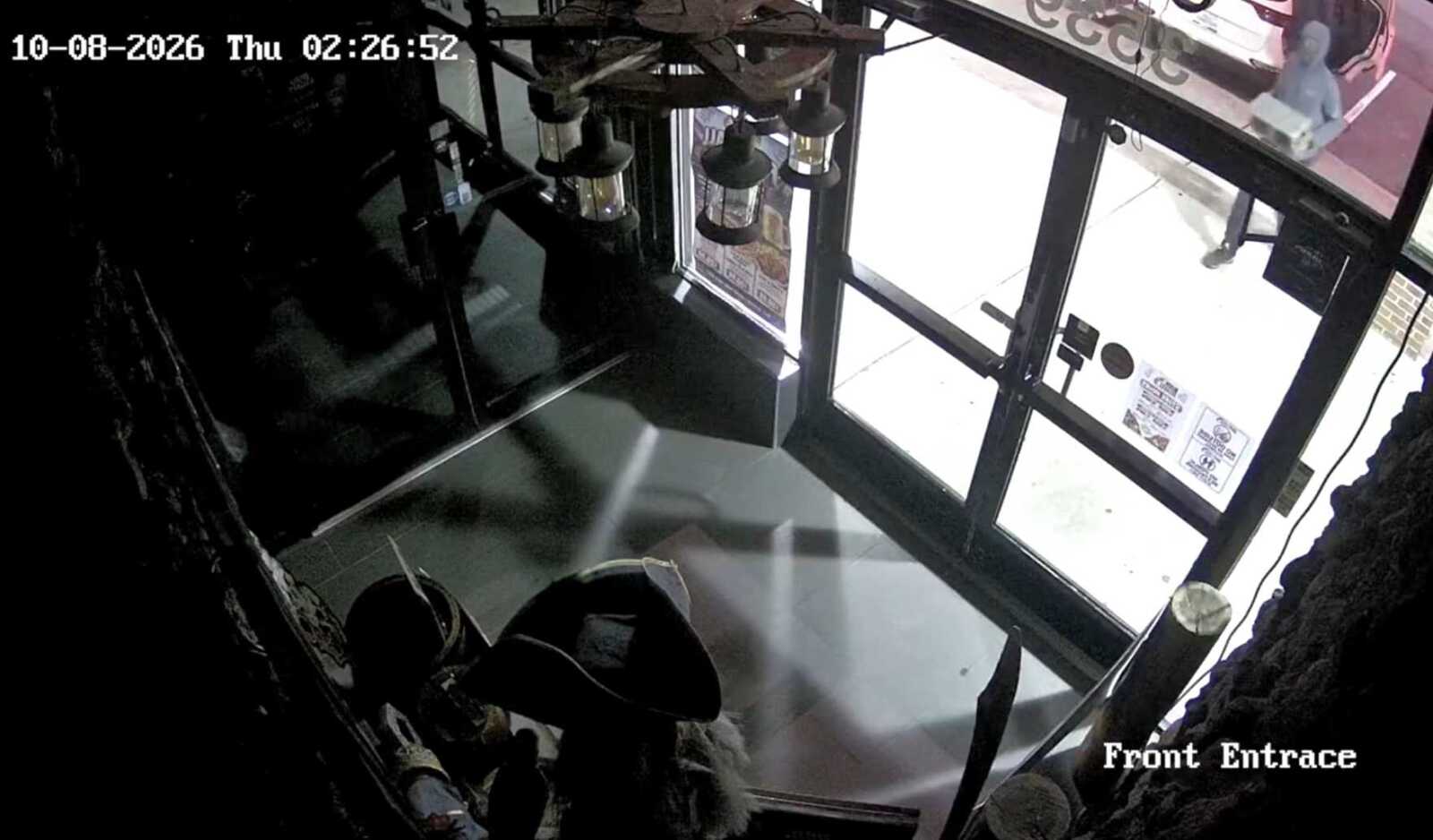 Surveillance footage of burglary at Hook & Reel in Bailey's Crossroads (via FCPD/YouTube) | FFXnow CCTV still of a front entrance lobby: glass doors, metal frame, interior on the left; timestamp 10-08-2026 Thu 02:26:52 in the top-left corner; 'Front Entrance' visible on the bottom-right.