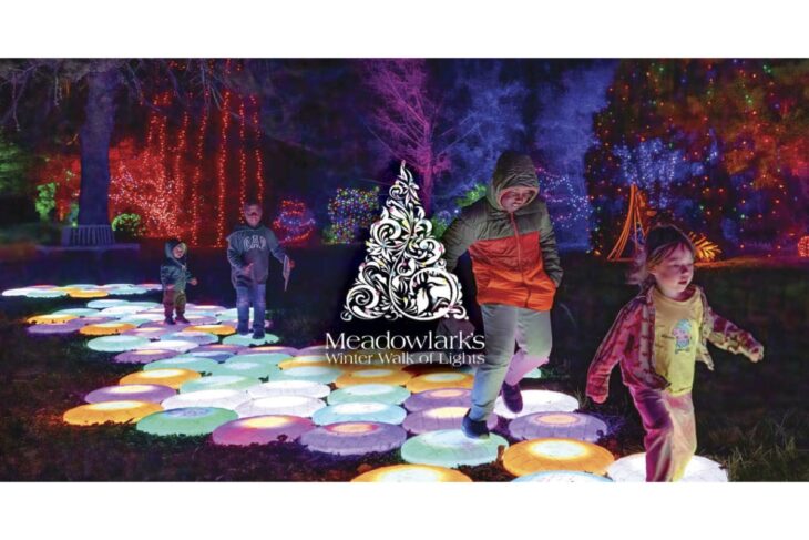 Children walking on glowing circular light tiles in a nighttime garden, with colorful holiday lights and Meadowlark's Winter Walk of Lights logo at the center.