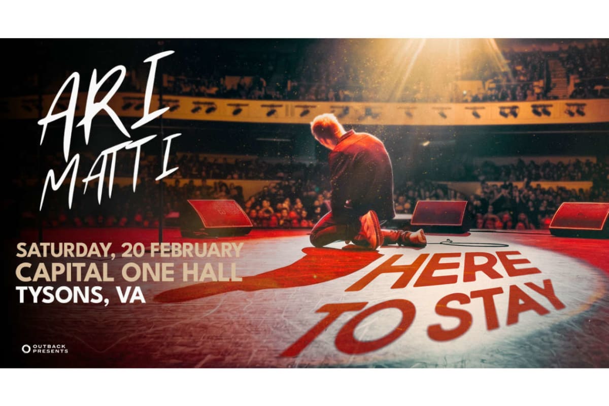 Poster for a live event: a performer kneels on a lit stage with an audience, bold text on the floor reads 'HERE TO STAY' and event details (Saturday, 20 February, Capital One Hall, Tysons, VA).