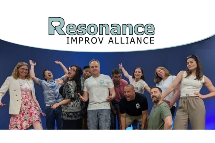 Group of diverse improv actors posing on a blue stage with the 'Resonance Improv Alliance' logo above them.